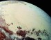 This Pluto mosaic was made from New Horizons LORRI images taken on July 14, 2015, from a distance of 49,700 miles (80,000 km). This view is projected from a point 1,118 miles (1,800 km) above Pluto’s equator, looking northeast over the dark, cratered Cthulhu Regio toward the bright, smooth expanse of icy plains called Sputnik Planum. Pluto’s North Pole is off the image to the left. This mosaic was produced with panchromatic images from the New Horizons LORRI camera, with color overlaid from the Ralph color mapper onboard New Horizons. Image credit: S.A. Stern et al.