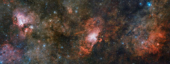 This trio of nebulae -- the Omega Nebula (left), the Eagle Nebula (center), and Sharpless 2-54 (right) -- makes up just a portion of a vast complex of gas and dust within which new stars are springing to life and illuminating their surroundings. Image credit: ESO.