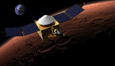 This artist’s concept shows MAVEN in orbit around Mars, with a fanciful image of Earth in the background. Image credit: NASA / GSFC.