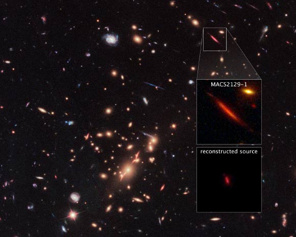 Acting as a ‘natural telescope’ in space, the gravity of the extremely massive foreground galaxy cluster MACS J2129-0741 magnifies, brightens, and distorts the far-distant background galaxy MACS 2129-1 (top box). The middle box is a blown-up view of the gravitationally lensed galaxy. In the bottom box is a reconstructed image, based on modeling that shows what MACS 2129-1 would look like if the galaxy cluster were not present. MACS 2129-1 appears red because it is so distant that its light is shifted into the red part of the spectrum. Image credit: NASA / ESA / S. Toft, University of Copenhagen / M. Postman, STScI / CLASH Team.