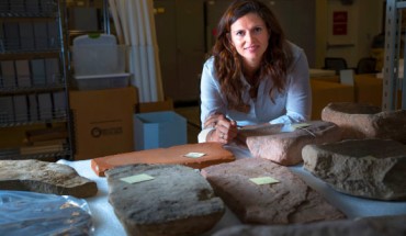 Dr. Louderback stands behind large stone metates, the grindstones on which ancient Native Americans processed their food. Image credit: University of Utah.