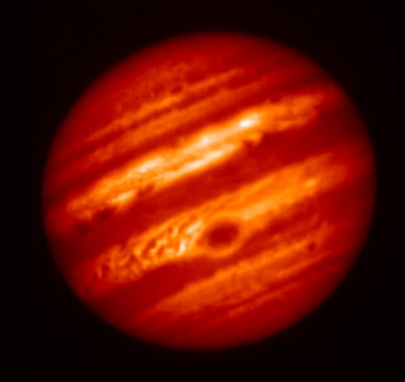 This false-color image of Jupiter was taken on May 18, 2017, with a mid-infrared filter centered at a wavelength of 8.8 microns, at the Subaru Telescope in Hawaii. The selected wavelength is sensitive to Jupiter’s tropospheric temperatures and the thickness of a cloud near the condensation level of ammonia gas. The GRS appears distinctively at the lower center of the planet as a cold region with a thick cloud layer. It is surrounded by a warm and relatively clear periphery. To its northwest is a turbulent and chaotic region where bands of gas that is warm and dry alternate with bands of gas that is cold and moist. Image credit: NAOJ / NASA / JPL-Caltech.