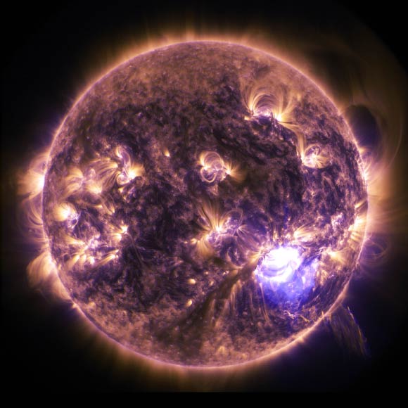 NASA’s Solar Dynamics Observatory captured an X-class solar flare erupting on the Sun on December 19, 2014. This image blends two wavelengths of extreme UV light, 171 (gold) and 131 (purple). Image credit: NASA / SDO / Duberstein.