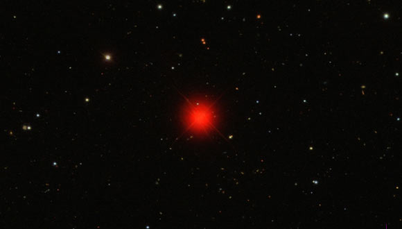 Ross 128 (center), also known as HIP 57548 or IRAS 11451+0105, is a red dwarf star. It has 15% of the mass of the Sun and 21% of the Sun’s radius, but generates energy so slowly that it has only 0.036% of the Sun’s visible luminosity. Image credit: Sloan Digital Sky Survey.