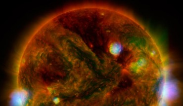 Flaring, active regions of the Sun are highlighted in this image combining observations from several telescopes. High-energy X-rays from NASA’s Nuclear Spectroscopic Telescope Array (NuSTAR) are shown in blue; low-energy X-rays from Japan’s Hinode spacecraft are green; and extreme ultraviolet light from NASA’s Solar Dynamics Observatory (SDO) is yellow and red. All three telescopes captured their solar images around the same time on April 29, 2015. Image credit: NASA / JPL-Caltech / GSFC / JAXA.
