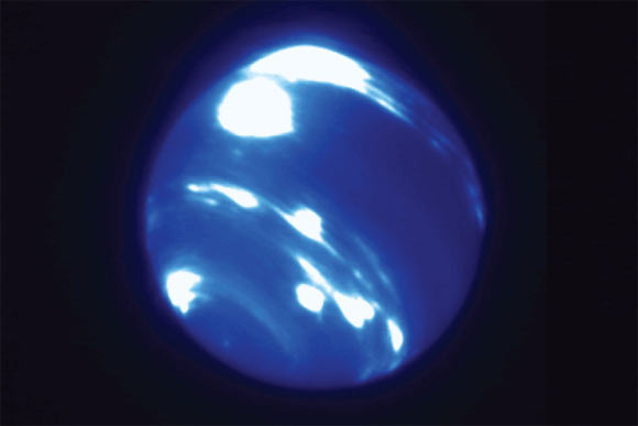 This image from the Keck Telescope shows an extremely bright, nearly circular storm system near Neptune’s equator. Image credit: Ned Molter & Imke de Pater, University of California, Berkeley / C. Alvarez, W. M. Keck Observatory.