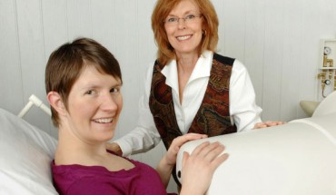 Dr. Gustafson with a mother-to-be in the fetal biomagnetometer. Image credit: University of Kansas.
