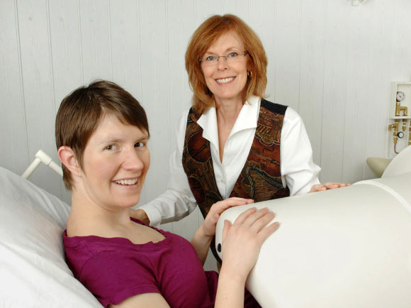 Dr. Gustafson with a mother-to-be in the fetal biomagnetometer. Image credit: University of Kansas.