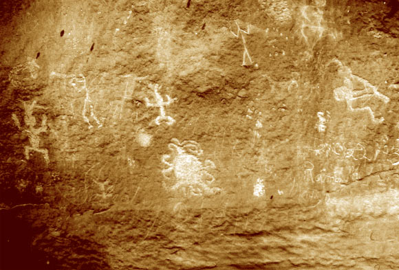 The south face of Piedra del Sol showing the eclipse petroglyph and two Kokopeli petroglyphs. Image credit: University of Colorado.