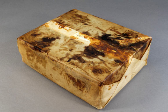 The 106-year-old fruit cake in wrapper. Image credit: New Zealand Antarctic Heritage Trust.