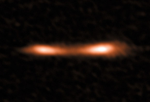 This ALMA image shows the Eyelash galaxy, a remote starburst galaxy that appears double and brightened by gravitational lensing. ALMA has been used to detect turbulent reservoirs of cold gas surrounding this and other distant starburst galaxies. By detecting CH+ for the first time in the distant Universe, this research opens up a new window of exploration into a critical epoch of star formation. Image credit: ALMA / ESO / NAOJ / NRAO / E. Falgarone et al.