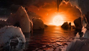 This artist’s concept allows us to imagine what it would be like to stand on the surface of TRAPPIST-1f. Because this planet is thought to be tidally locked to its star, meaning the same face of the planet is always pointed at the star, there would be a region called the terminator that perpetually divides day and night. If the night side is icy, the day side might give way to liquid water in the area where sufficient starlight hits the surface. One of the unusual features of TRAPPIST-1 planets is how close they are to each other -- so close that other planets could be visible in the sky from the surface of each one. In this view, the planets in the sky correspond to TRAPPIST1e (top left crescent), d (middle crescent) and c (bright dot to the lower right of the crescents). TRAPPIST-1e would appear about the same size as the Moon and TRAPPIST1-c is on the far side of the star. The star itself, an ultra-cool dwarf, would appear about three times larger than our own Sun does in Earth’s skies. Image credit: NASA / JPL-Catlech.