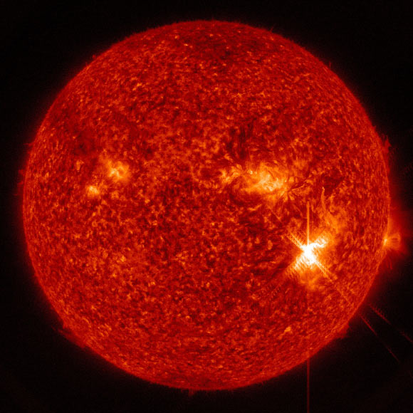 An X9.3-class solar flare flashes in the middle of the Sun on September 6, 2017. This image was captured by NASA’s Solar Dynamics Observatory at 11:58:42 UTC and shows light in the 304 angstrom wavelength. Image credit: NASA / GSFC / SDO.