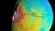 A new map of the thickness of the Martian crust shows less variation between thicker regions (red) and thinner regions (blue), compared to earlier mapping. This view is centered on Valles Marineris, with the Tharsis Montes near the terminator to its west. The map is based on modeling of Mars’ gravity field by Goossens et al. Image credit: NASA / Goddard / UMBC / MIT / E. Mazarico.