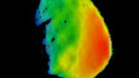This image combines two products from the first pointing at Phobos by Mars Odyssey’s THEMIS camera. Surface-temperature information from observation in thermal-infrared wavelengths is overlaid on a more detailed image from a visible-light observation. The left edge of the small moon was in darkness, and the right edge in morning sunlight. The distance to Phobos from Mars Odyssey during the observation was about 3,424 miles (5,511 km). Researchers will analyze the surface-temperature information from this observation and possible future THEMIS observations to learn how quickly the surface warms after sunup or cools after sundown. That could provide information about surface materials, because larger rocks heat or cool more slowly than smaller particles do. The thermal information in this image is from merging observations made in four thermal-infrared wavelength bands, centered from 11.04 microns to 14.88 microns. Image credit: NASA / JPL-Caltech / Arizona State University.