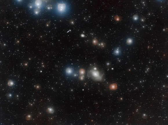 Countless galaxies vie for attention in this VST image of the Fornax Cluster (also known as ACO S 373 and MCL 52), some appearing only as pinpricks of light while others dominate the foreground. One of these is the lenticular galaxy NGC 1316. Image credit: A. Grado & L. Limatola, ESO.