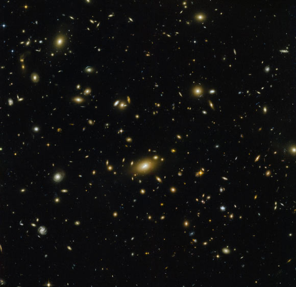 This image, taken with ACS and WFC3 cameras on board the NASA/ESA Hubble Space Telescope, shows the massive galaxy cluster Abell 1300. Seven filters were used to sample various wavelengths. The color results from assigning different hues to each monochromatic image associated with an individual filter. Image credit: NASA / ESA / Hubble.