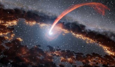 This illustration shows a stream of material from a star as it is being devoured by a supermassive black hole in a tidal disruption flare. Image credit: NASA / JPL-Caltech.