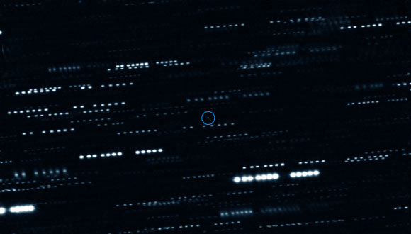 This very deep combined image shows ’Oumuamua. It is surrounded by the trails of faint stars that are smeared as the telescopes tracked the moving asteroid. This image was created by combining multiple images from ESO’s Very Large Telescope as well as the Gemini South Telescope. The object is marked with a blue circle and appears to be a point source, with no surrounding dust. Image credit: ESO / K. Meech et al.