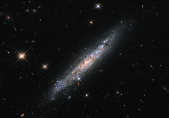 This image, taken with the Wide-Field Camera 3 (WFC3) on board the NASA/ESA Hubble Space Telescope, shows the spiral galaxy LEDA 53183. Three filters were used to sample various wavelengths. The color results from assigning different hues to each monochromatic image associated with an individual filter. Image credit: NASA / ESA / Hubble.