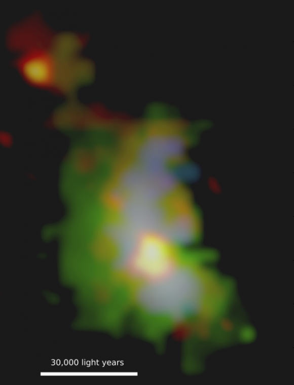 This image shows the galaxy 3C 298, located approximately 9.3 billion light-years away. The green colors highlight the energetic gas across the galaxy that is being illuminated by the quasar. The blue color represents powerful winds blowing throughout the galaxy. The red-orange colors represent the cold molecular gas in the system. The supermassive black hole sits at the center of the bright red-orange circular area slightly below the middle of the image. Image credit: Vayner et al.