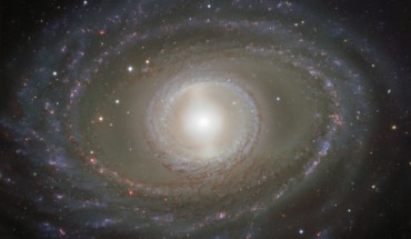 This image shows spectacular ribbons of gas and dust wrapping around the pearly center of the barred spiral galaxy NGC 1398. Image credit: ESO.