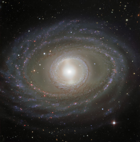 This image shows spectacular ribbons of gas and dust wrapping around the pearly center of the barred spiral galaxy NGC 1398. Image credit: ESO.