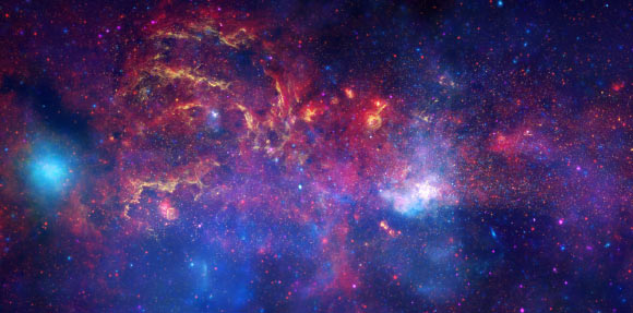 This composite image shows the central region of our Milky Way Galaxy. The Galactic center is located within the bright white region to the right of and just below the middle of the image. Image credit: NASA / ESA / SSC / CXC / STScI.