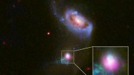 This image shows the SDSS J1354+1327 galaxy in a composite image with data from Chandra (purple), and Hubble (red, green and blue). The inset box contains a close-up view of the central region around SDSS J1354+1327’s supermassive black hole. The larger companion galaxy, SDSS J1354+1328, is shown to the north. Image credit: NASA / CXC / University of Colorado / STScI/ J. Comerford et al.