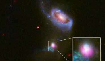 This image shows the SDSS J1354+1327 galaxy in a composite image with data from Chandra (purple), and Hubble (red, green and blue). The inset box contains a close-up view of the central region around SDSS J1354+1327’s supermassive black hole. The larger companion galaxy, SDSS J1354+1328, is shown to the north. Image credit: NASA / CXC / University of Colorado / STScI/ J. Comerford et al.