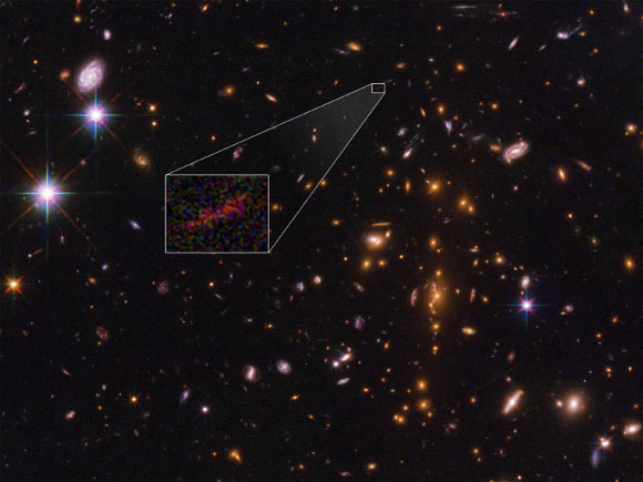 Salmon et al were able to detect a hint of light from SPT0615-JD because it was magnified as it passed around the massive galaxy cluster SPT-CL J0615-5746 as it traveled towards Earth. Image credit: NASA / ESA / B. Salmon, STScI.