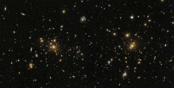 This Hubble image shows A1758N, the northern part of the galaxy cluster Abell 1758. The cluster is approximately 3.2 billion light-years from Earth and is part of a larger structure containing two clusters sitting some 2.4 million light-years apart. But A1758N itself is further split into two sub-sections, known as East (A1758NE) and West (A1758NW). Image credit: NASA / ESA / Hubble.