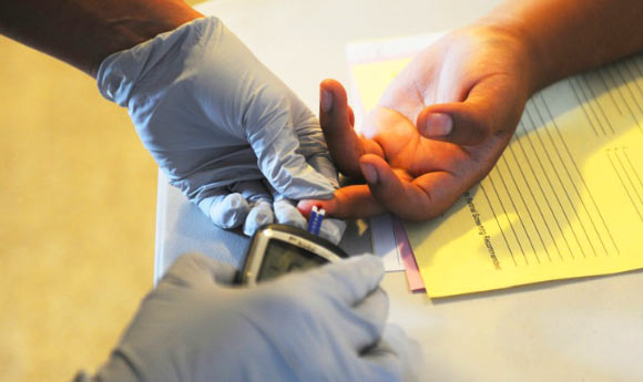 A person performs a glucose screening. Image credit: Sgt. Jessica A. DuVernay, U.S. Army.