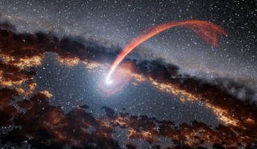 This illustration shows a glowing stream of material from a star, disrupted as it was being devoured by a supermassive black hole. When a star passes within a certain distance of a black hole -- close enough to be swallowed up -- the stellar material gets stretched and compressed as it is pulled in. A black hole’s destruction of a star, called ‘stellar tidal disruption,’ releases an enormous amount of energy, brightening the surroundings in an event called a flare. Image credit: NASA / JPL-Caltech.