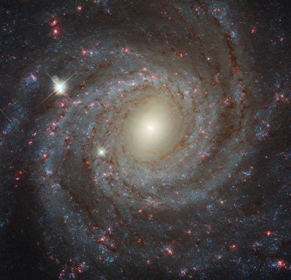 This image of NGC 3344 is a composite of separate exposures acquired by Hubble’s Wide Field Camera 3 (WFC3). Seven filters were used to sample various wavelengths. They cover wavelengths from the ultraviolet to the optical and the near-infrared. Together they create a detailed picture of the galaxy and allow astronomers to study many different aspects of it. Image credit: NASA / ESA / Hubble.