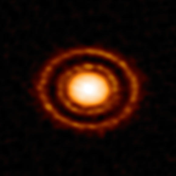 This wonderful image was captured using ALMA, revealing a curious pattern of rings and gaps in the dust surrounding the young star AS 209. Image credit: ALMA / ESO / NAOJ / NRAO / D. Fedele et al.
