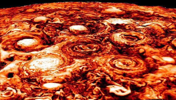This computer-generated image shows the structure of the cyclonic pattern observed over Jupiter’s south pole. Like in the North, Jupiter’s south pole also contains a central cyclone, but it is surrounded by five cyclones with diameters ranging from 3,500 to 4,300 miles (5,600 to 7,000 km) in diameter. Almost all the polar cyclones (at both poles), are so densely packed that their spiral arms come in contact with adjacent cyclones. The data used in generating this image was collected by the JIRAM instrument aboard Juno during the fourth Juno pass over Jupiter on February 2, 2017. Image credit: NASA / JPL-Caltech / SwRI / ASI / INAF / JIRAM.