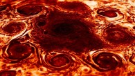 This composite image, derived from data collected by the JIRAM instrument aboard NASA’s Juno orbiter, shows the central cyclone at Jupiter’s north pole and the eight cyclones that encircle it. JIRAM collects data in infrared, and the colors in this composite represent radiant heat: the yellow (thinner) clouds are about 9 degrees Fahrenheit (minus 13 degrees Celsius) in brightness temperature and the dark red (thickest) are around minus 181 degrees Fahrenheit (83 degrees Celsius). Image credit: NASA / JPL-Caltech / SwRI / ASI / INAF / JIRAM.