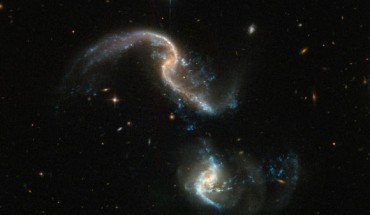 This spectacular image of Arp 256 is a composite of separate exposures acquired by Hubble’s Advanced Camera for Surveys (ACS) and the Wide Field Camera 3 (WFC3). Image credit: NASA / ESA / Hubble.
