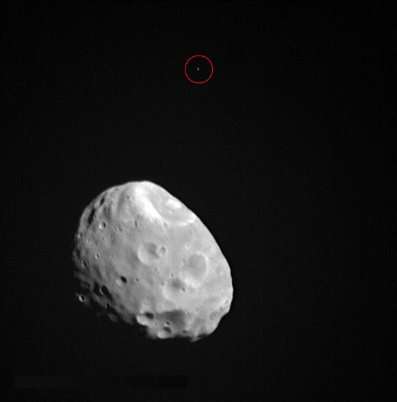This image of Phobos was taken by the Super Resolution Channel of Mars Express’ High Resolution Stereo Camera. In the foreground sits Phobos; in the background is a reference star (circled in red) used to pinpoint the moon’s position. This image was taken during Mars Express orbit 17,746 on January 8, 2018. Image credit: ESA / DLR / FU Berlin / CC BY-SA 3.0 IGO.
