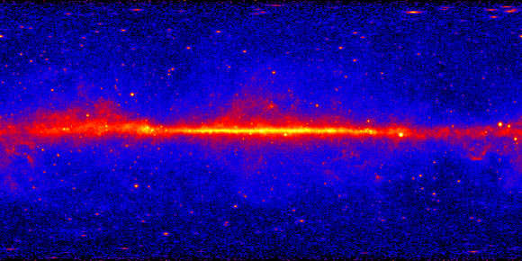This view shows the entire sky at energies greater than 1 GeV based on five years of data from the LAT instrument on NASA’s Fermi Gamma-ray Space Telescope; the most prominent feature is the bright band of diffuse glow along the map’s center, which marks the central plane of our Milky Way Galaxy. Image credit: NASA / DOE / Fermi LAT Collaboration.