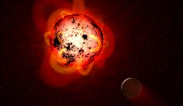 This illustration shows a red dwarf star orbited by a hypothetical exoplanet. Red dwarfs tend to be magnetically active, displaying gigantic arcing prominences and a wealth of dark sunspots. Red dwarfs also erupt with intense flares that could strip a nearby planet’s atmosphere over time, or make the surface inhospitable to life as we know it. Image credit: NASA / ESA / STScI / G. Bacon.