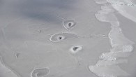 This image shows curious holes in Arctic sea ice, located about 50 miles (80.5 km) northwest of Canada’s Mackenzie River Delta. Image credit: John Sonntag / NASA’s Operation IceBridge Mission.