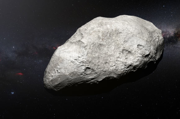 This artist’s impression shows 2004 EW95, the first carbon-rich asteroid confirmed to exist in the Kuiper Belt and a relic of the primordial Solar System. 2004 EW95 likely formed in the main asteroid belt and has been flung billions of miles from its origin to its current home in the Kuiper Belt. Image credit: M. Kornmesser / ESO.