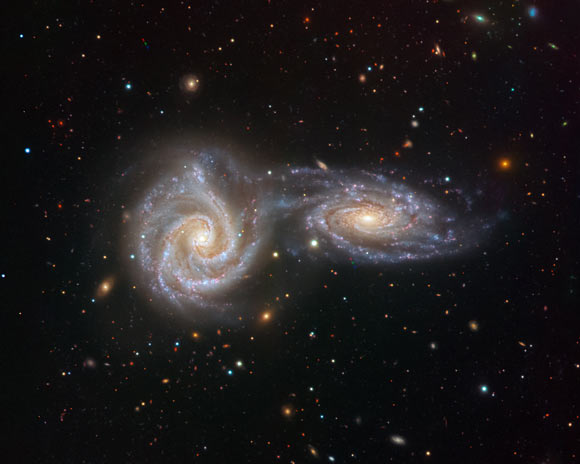 Two spiral galaxies NGC 5426 and NGC 5427 are locked in a swirling dance in this image from the VIMOS instrument on ESO’s Very Large Telescope. Image credit: Juan Carlos Muñoz / ESO.