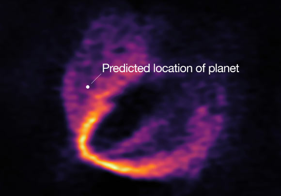 This image shows part of the ALMA data set at one wavelength and reveals a clear ‘kink’ in the material, which indicates unambiguously the presence of one of the HD 163296 planets; the annotation shows the predicted position of the planet in question. Image credit: ESO / ALMA / NAOJ / NRAO / Pinte et al.