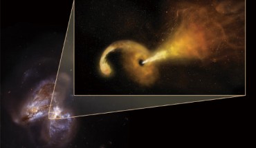 An artist’s conception of a tidal disruption event in the merging galaxy pair Arp 299; background is the Hubble image of Arp 299. Image credit: Sophia Dagnello / NRAO / AUI / NSF / NASA / STScI.