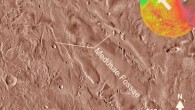 The Medusae Fossae Formation is one of the largest sedimentary deposits on Mars. This is an infrared image mosaic generated using Thermal Emission Imaging System (THEMIS) images from NASA’s Mars Odyssey orbiter mission; the small colored globe based on the Mars Orbiter Laser Altimeter (MOLA). Image credit: NASA.
