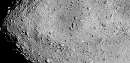 Hayabusa-2 image of the asteroid Ryugu as seen from a distance of 3.7 miles. A particularly large crater is visible near the center of the image. Image credit: JAXA / University of Tokyo / Kochi University / Rikkyo University / Nagoya University / Chiba Institute of Technology / Meiji University / University of Aizu / AIST.