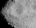 Hayabusa-2 image of the asteroid Ryugu as seen from a distance of 3.7 miles. A particularly large crater is visible near the center of the image. Image credit: JAXA / University of Tokyo / Kochi University / Rikkyo University / Nagoya University / Chiba Institute of Technology / Meiji University / University of Aizu / AIST.